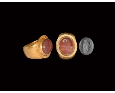 2nd-3rd century AD. A gold finger ring comprising a D-section hoop, bezel with applied fluted rim, cell with inset carnelian 