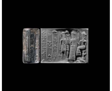 16th-19th century BC. A haematite cylinder seal with a king with a mace facing a suppliant goddess Lama in a flounced robe, w