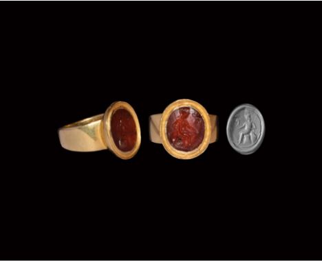 2nd century AD. A carnelian cloison with intaglio seated Victory with spear, shield and helmet, frond by the foot, miniature 