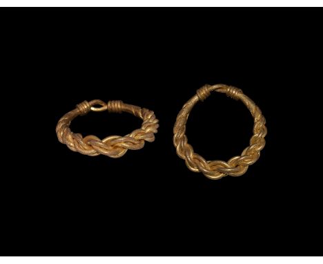 9th-11th century AD. A gold ring with hoop of four expanding rods plaited, looped to the reverse and the ends wound about the