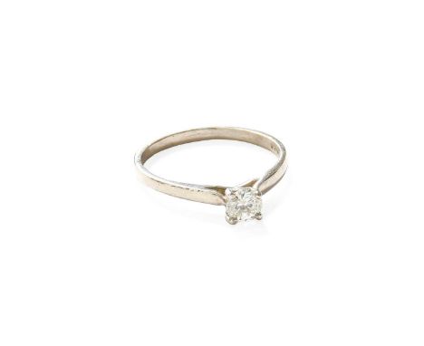 A Platinum Diamond Solitaire Ring, the round brilliant cut diamond in a four claw setting, to a tapered shoulder plain polish