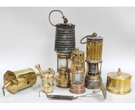 A WWI Trench Art Tobacco Jar with Cover; together with a small trench art pestle and mortar, three various miner's lamps and 