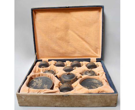 A Cased Japanese Satsuma Earthenware Tea Service, Taisho period, in fitted case, matt black ground and with blossom in gilt, 