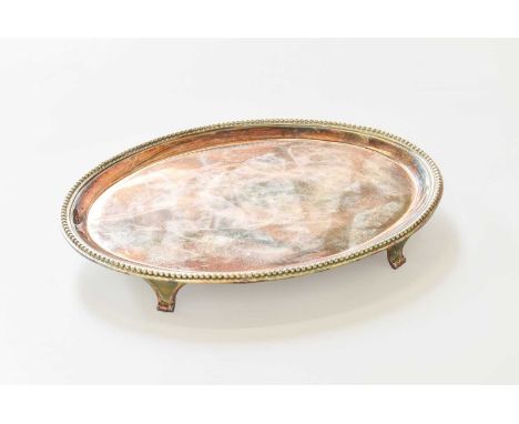 A George III Silver Teapot-Stand, by Elizabeth Jones, London, 1784, oval and on four tapering panel feet, with beaded border,