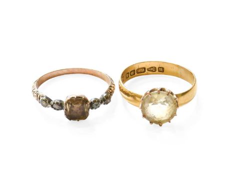 A 22 Carat Gold Citrine Ring, the round cut citrine in a yellow claw setting, to a plain polished shank, finger size R; and A