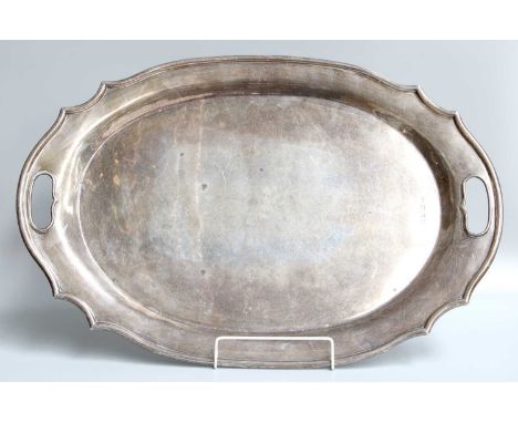 A George V Silver Tray, by Albert Cowley Bloxham, London, 1926, shaped oval and with two intergral handles, 59.5cm wide, 84oz