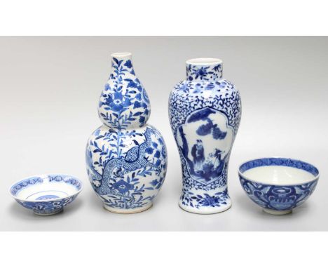 A Chinese Porcelain Vase, 19th century, painted in underglaze blue with dragons, Kangxi mark, a similar baluster vase and a b