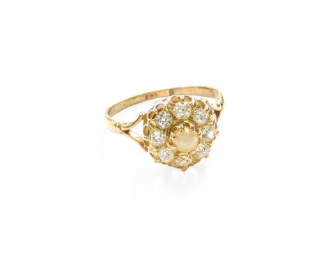 A Cultured Pearl and Diamond Cluster Ring, the central raised cultured pearl within a border of old cut diamonds, in yellow c