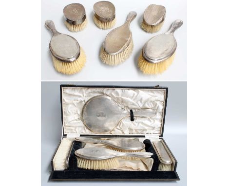 A Collection of Silver-Backed Dressing-Table Items, comprising a cased five-piece set with engine-turned decoration, comb lac