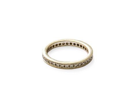 A Diamond Eternity Ring, the round brilliant cut diamonds in white claw and channel settings, total estimated diamond weight 