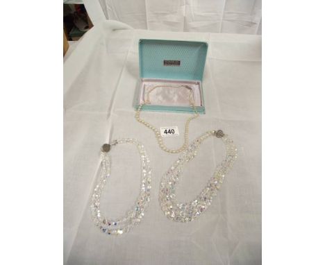 2 crystal necklaces and a pearl necklace