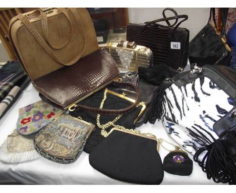 A quantity of vintage handbags.
