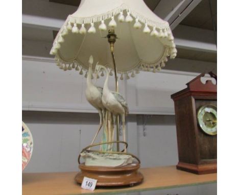 A table lamp in the form of a pair of storks complete with shade,  Tail on one bird a/f.