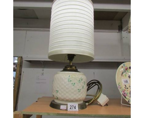 A Belleek table lamp with shade.