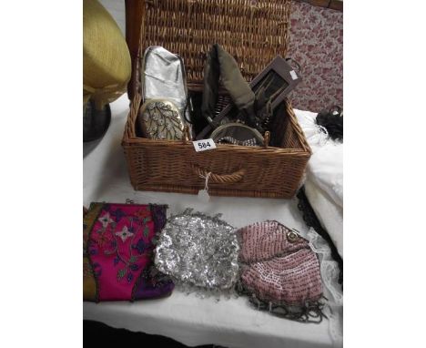 A wicker basket containing vintage evening bags etc.,