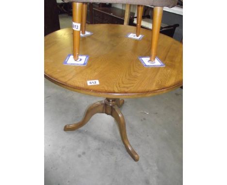 A solid oak tripod table.