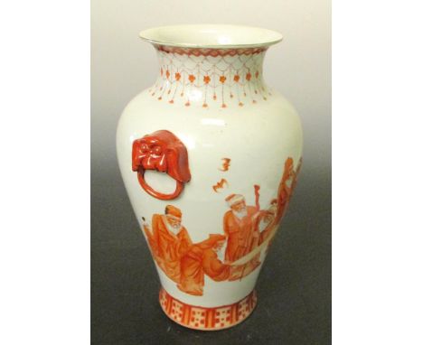 A late 19th/early 20th century rouge de fer vase, the baluster shape painted with jewel hung neck above while sages examine a