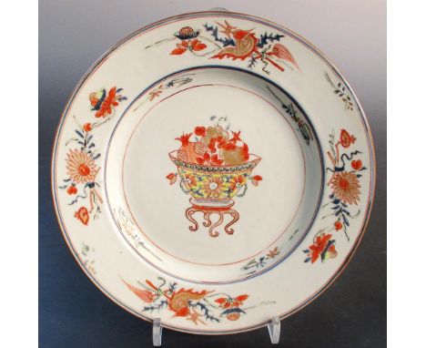 A famille verte plate, period of Kangxi, painted with a bowl of pomegranates centrally to flowers alternating with lotus and 