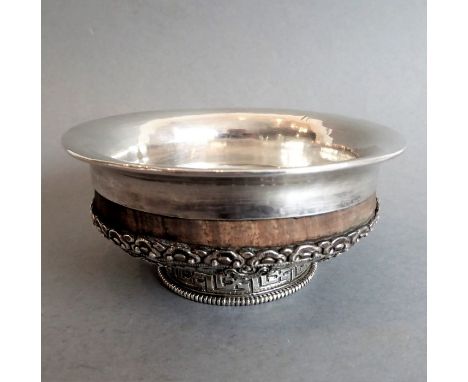 A circa 1910&nbsp;Chinese export ware silver and hardwood bowl; the bowl of footed form embossed and chased with eight Chines