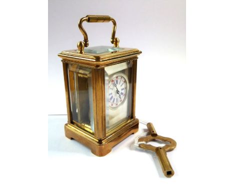 A miniature brass carriage clock with key