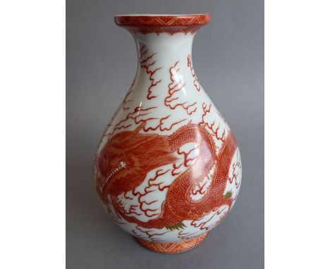 A Chinese porcelain vase of baluster form. The lip painted with ruyi heads above a waisted neck leading to the body decorated