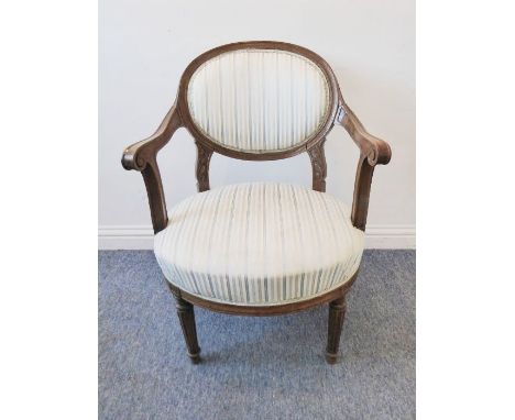 A late 19th / early 20th century upholstered oak open-armed fauteuil; in French style, blue and light-brown striped upholster