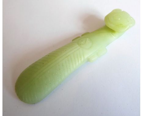 A Chinese carved pale celadon/white jade Ruyi sceptre (9.5cm)