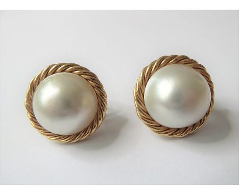 A pair of mabé pearl and 18-carat yellow-gold ear clips each comprising a mabé pearl measuring 14mm in diameter to the hallma