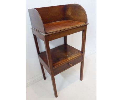 A George III period mahogany washstand; the three quarter galleried top with jug and basin apertures above a single full-widt