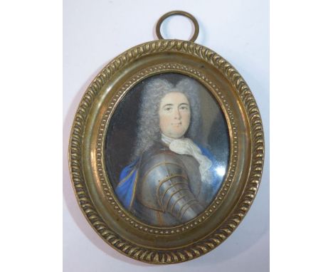 A fine oval brass-cased shoulder-length 17th-century-style (possibly period) portrait miniature; the young gentleman with lon