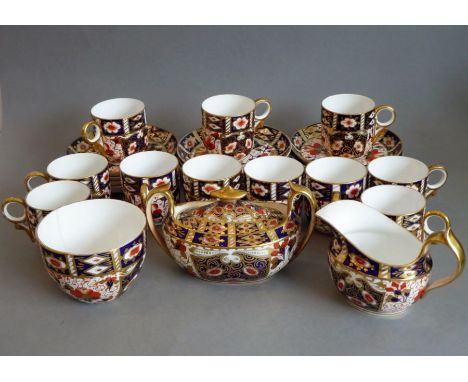 Hand-gilded and painted ceramics in the Imari pattern; to include eleven Royal Crown Derby coffee cans (one hairlined to base