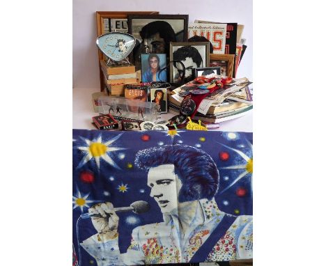 A large variety of Elvis Presley memorabilia to include a 1950s-style alarm clock, various printed ephemera, mirrors, belt bu