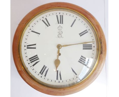 An early 20th century circular mahogany cased stationmaster's style wall-hanging clock, white-enamel dial with Roman numerals