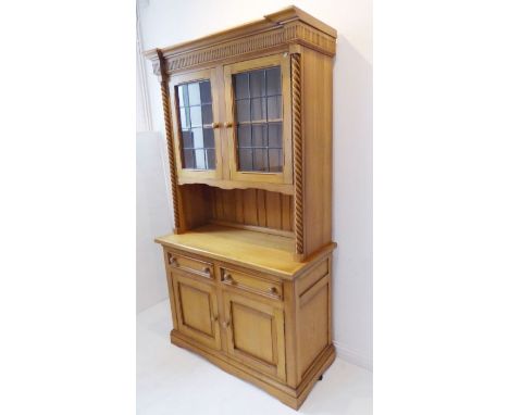 A 19th-century-style oak dresser (modern); the arcaded cornice above two leaded-light doors and flanked by barley-twist uprig