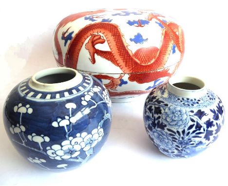 A Chinese porcelain bowl-and-cover and two blue-and-white jars: the large and heavy bowl hand-decorated with two four-clawed 