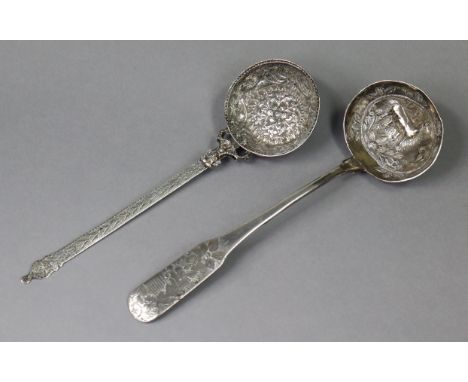 A continental white metal ladle, possibly Spanish colonial, the circular bowl embossed with birds &amp; flowers, &amp; with e