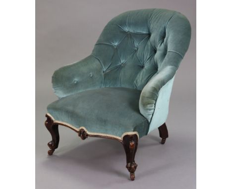 A Victorian easy chair with buttoned back &amp; arms upholstered blue velour, on short carved cabriole legs with ceramic cast