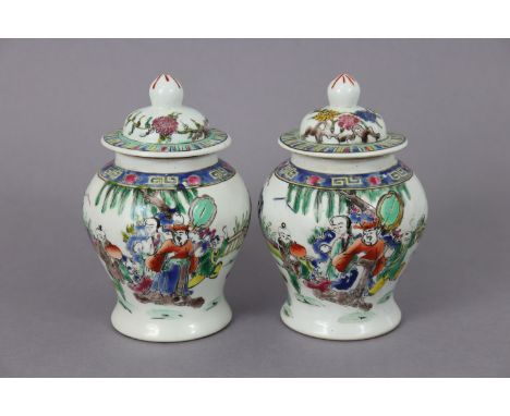 A pair of Chinese porcelain small baluster vases &amp; covers, each decorated in famille verte enamels with figures in a form