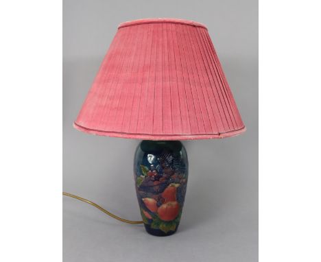 A Moorcroft pottery table lamp decorated with birds, apples, &amp; bunches of grapes, 18” high over-all, with shade; an S. Ha