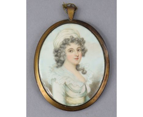 A 19th century head-&amp;-shoulders oval portrait miniature of a lady wearing pale green blouse &amp; silk headscarf, 3½” x 2