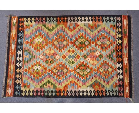 A Chobi kilim rug of deep blue ground with central multicoloured geometric panel &amp; guard stripes; 5’ x 3’3”.