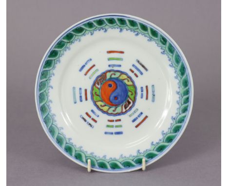 A Chinese porcelain 8” plate decorated with Ying-yang &amp; trigrams in a wave-&amp;-rock border in doucat enamels, Daoguang 