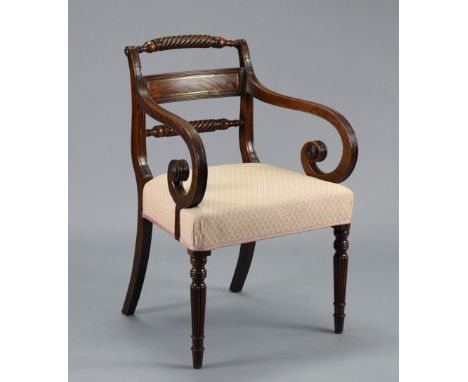 A Wm IV mahogany open armchair with brass-inlaid figured panel to the rope-twist back, reeded scroll arms with applied rounde