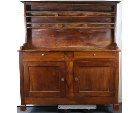 A 19th century French fruitwood dresser with two open shelves above two frieze drawers &amp; a cupboard enclosed by pair of f