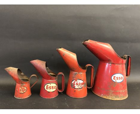 Four graduated Esso oil measures, the largest being a gallon. 
