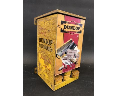 A Dunlop Accessories repair kit dispensing cabinet with four tins inside, 5 1/2" wide x 9" high x 4 3/4" deep. 