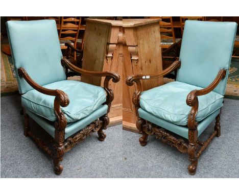 A pair 20th century Jacobian revival carved walnut armchairs, ornamented with acanthus scrolls and bobbin turn stretchers