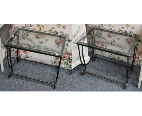 A pair of modern glass topped lamp tables on scrollwork metal bases (2)