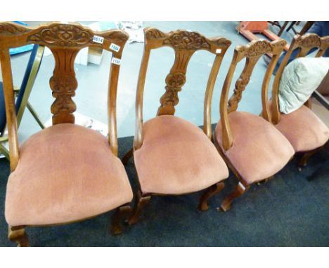 OAK DINING CHAIRS. Set of four antique oak upholstered dining chairs with arts and crafts carved backs and ceramic castors