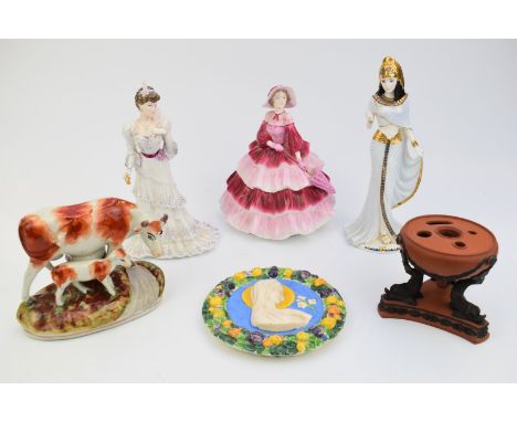 Three Coalport figurines including Cleopatra, Wedgwood terracotta, Staffordshire cow and calf, an Italian ceramic plaque poss